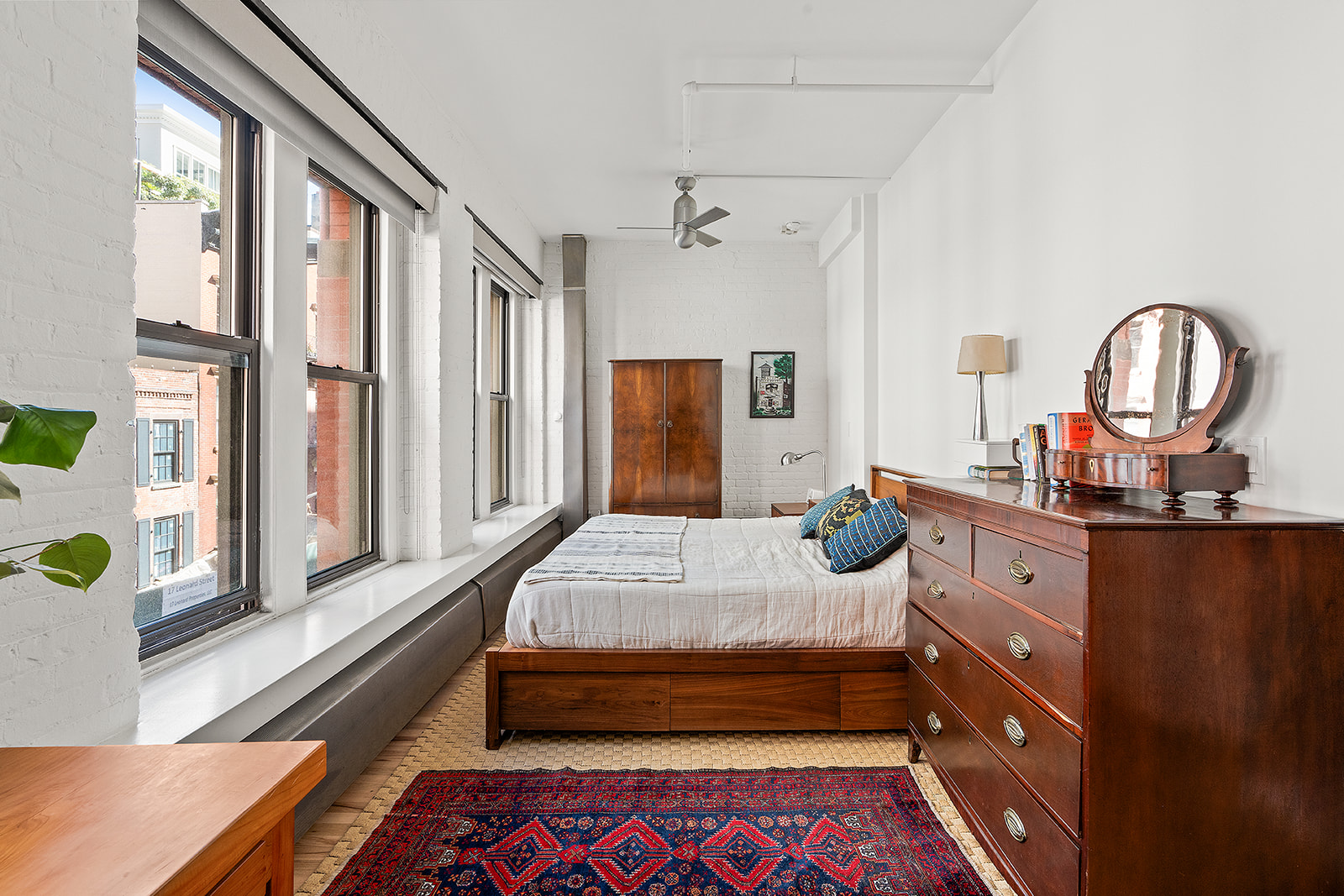 10 Leonard Street, Unit 3N Manhattan, NY 10013 - Photo 7 of 10 a bedroom with a bed a dresser and windows