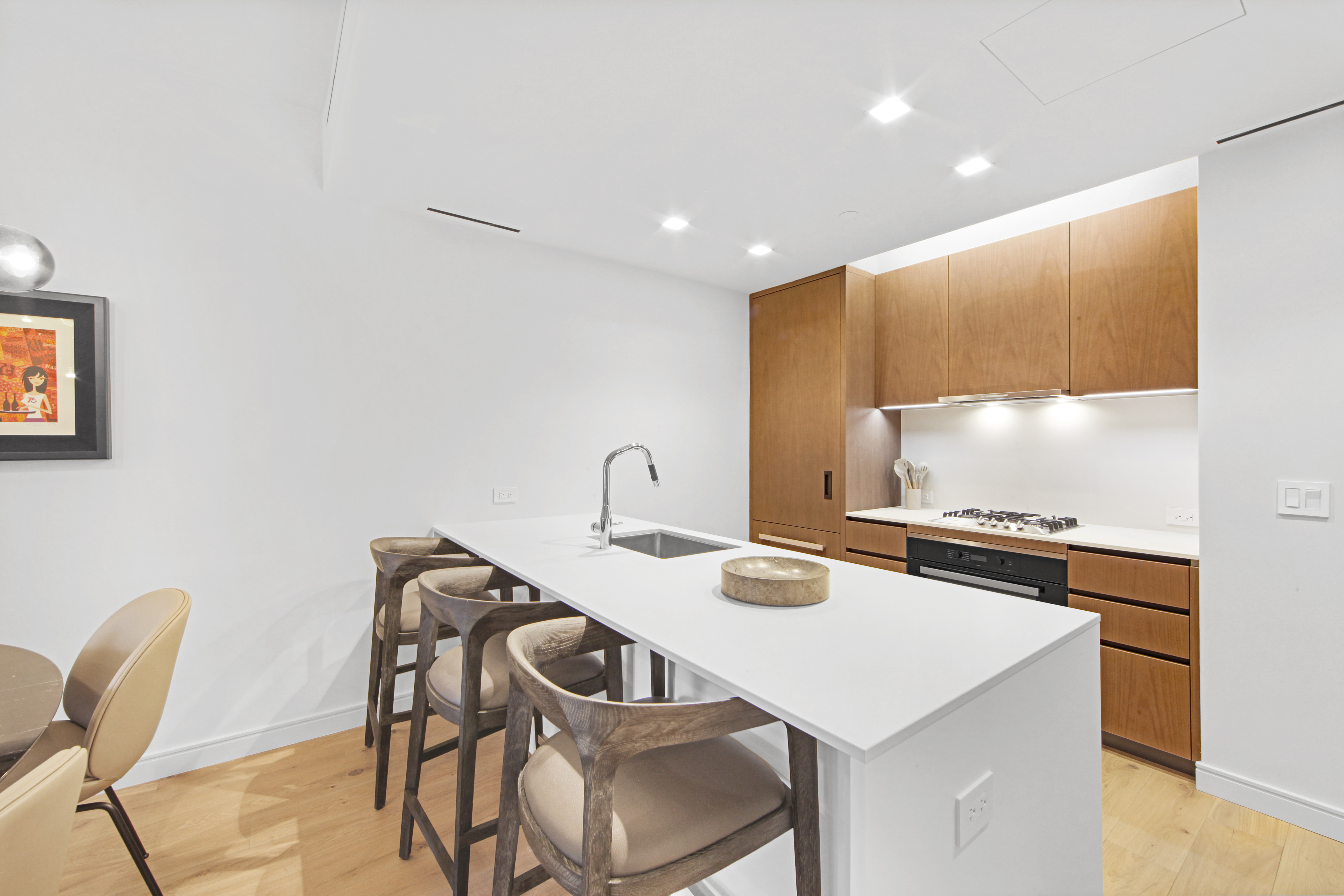 200 East 21st Street, Unit 4B Manhattan, NY 10010 - Photo 6 of 15 a kitchen with a table chairs and a refrigerator