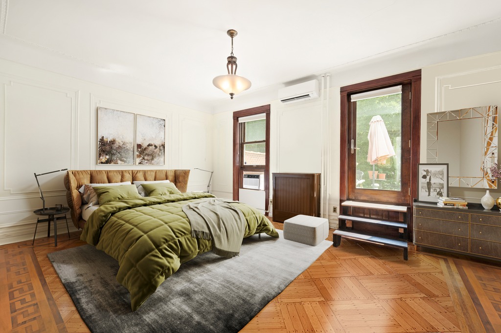 524 3rd Street Brooklyn, NY 11215 - Photo 10 of 18 a bedroom with a bed and a chandelier