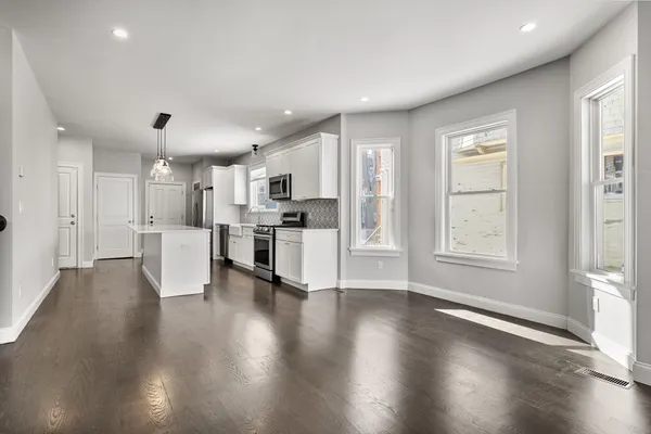 a view of kitchen with wooden floor and electronic appliances