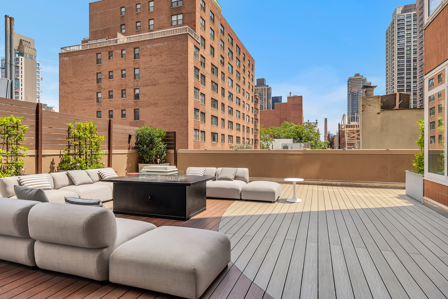 205 East 59th Street, Unit 14B Manhattan, NY 10022 - Photo 18 of 19 a view of a rooftop deck with couches and potted plants