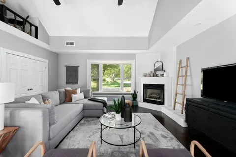 a kitchen with white cabinets and wooden floors