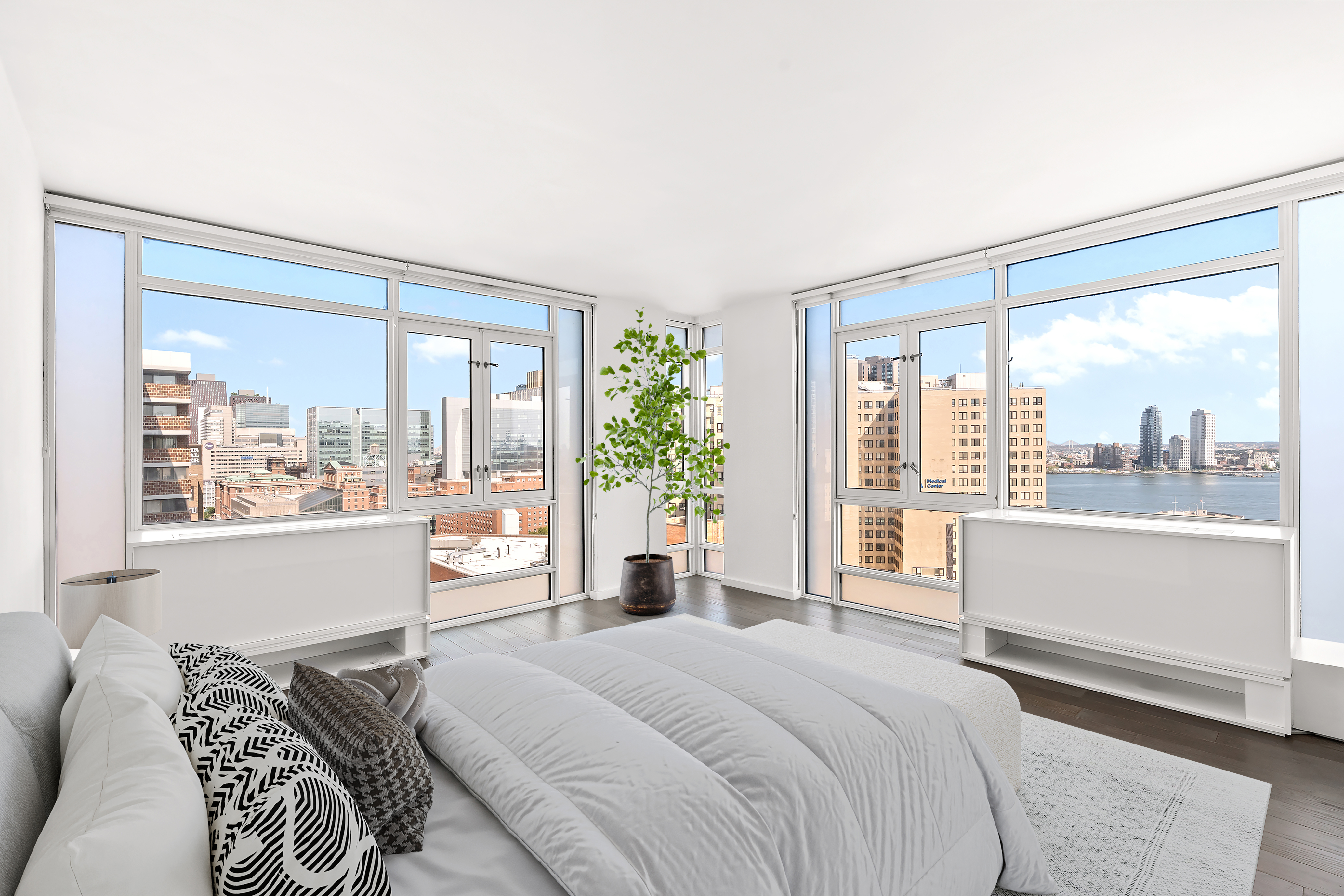 385 1st Avenue, Unit 20B Manhattan, NY 10010 - Photo 3 of 10 a bedroom with a large bed and a large window with the outer view