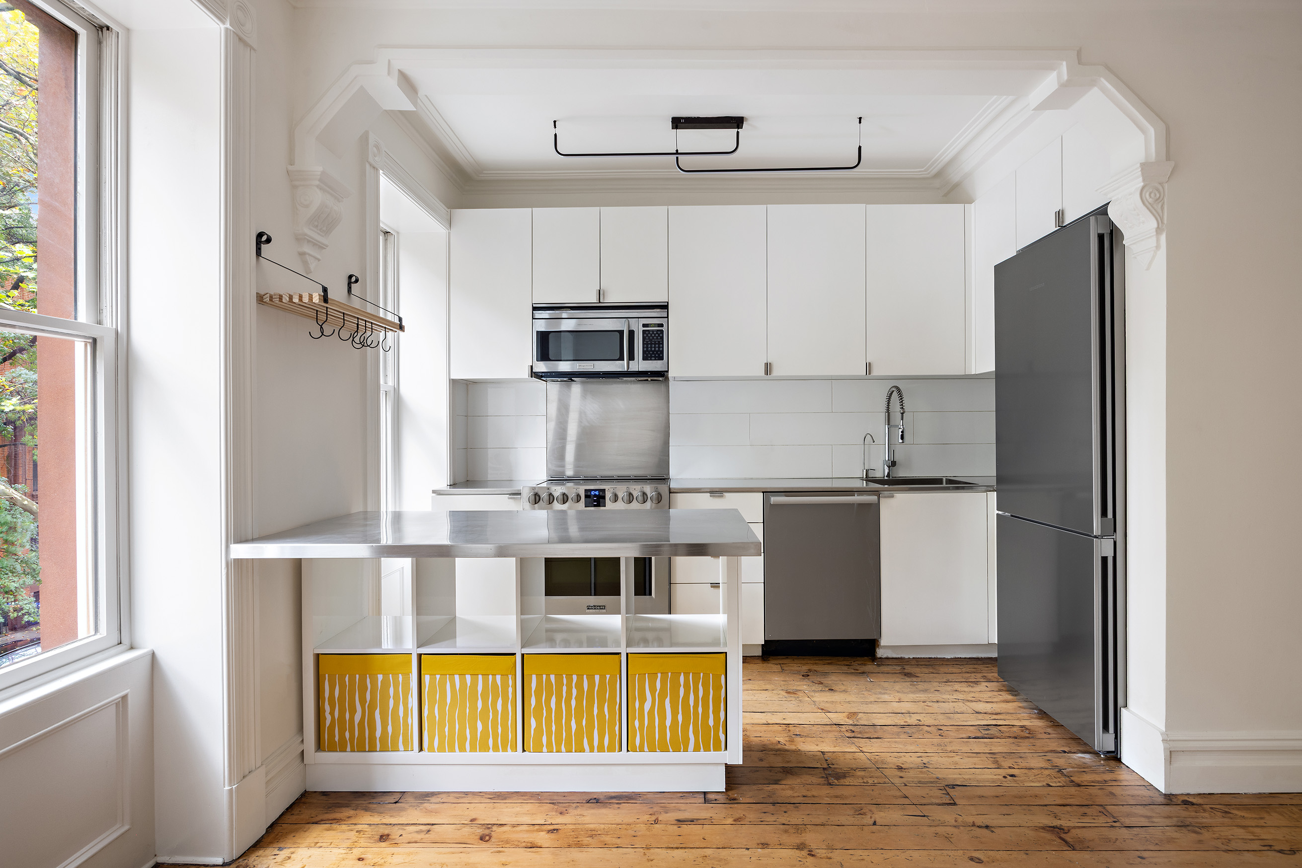 64 Clifton Place, Unit 2 Brooklyn, NY 11238 - Photo 3 of 16 a kitchen with stainless steel appliances granite countertop a refrigerator a stove and a sink