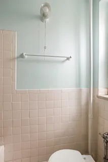 a bathroom with a toilet and shower
