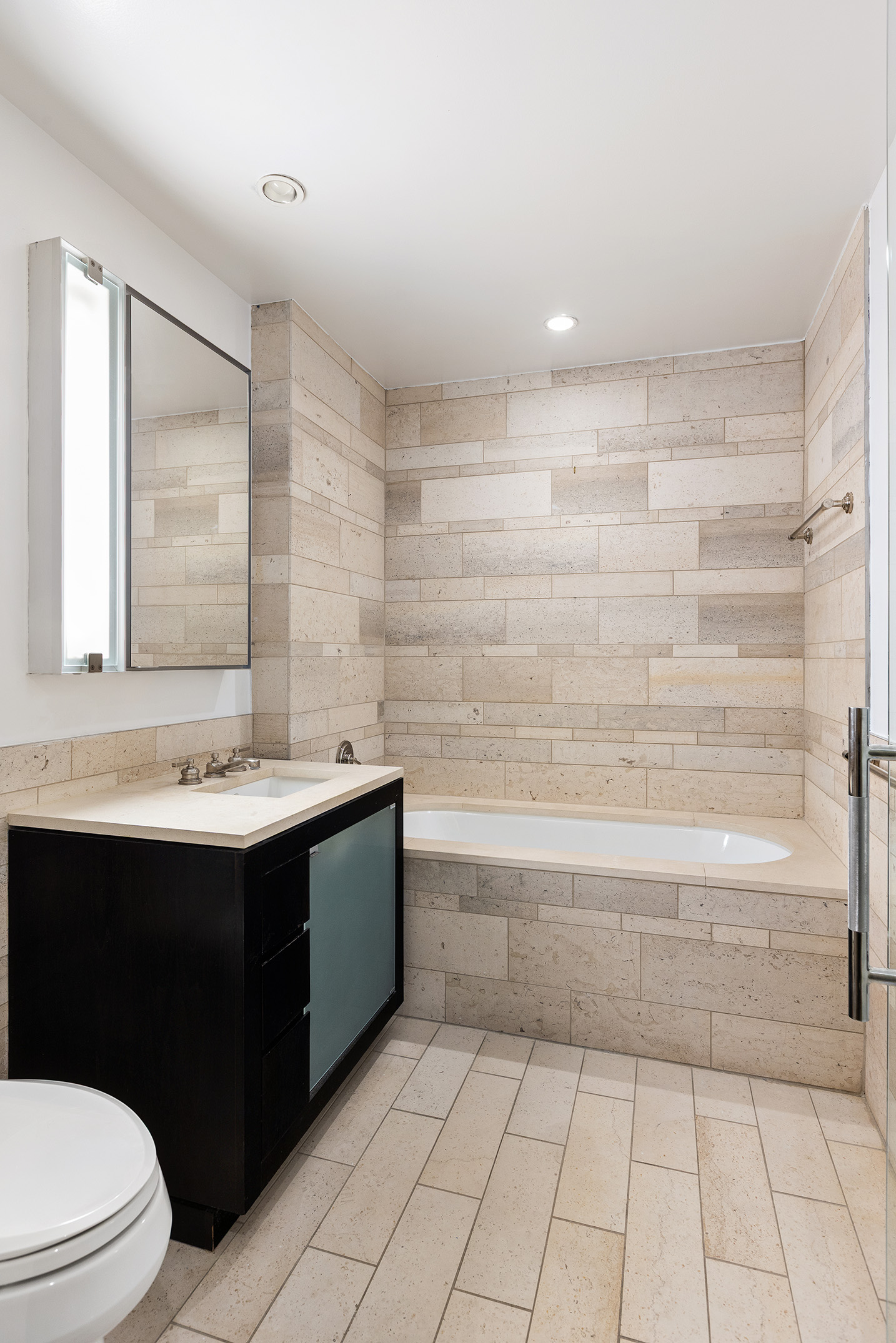 450 East 83rd Street, Unit 8B Manhattan, NY 10028 - Photo 9 of 22 a bathroom with a sink a toilet and bathtub