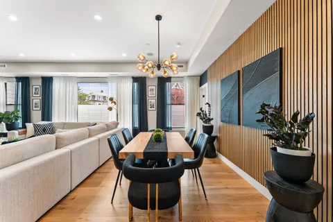 a view of a dining room with furniture and wooden floor
