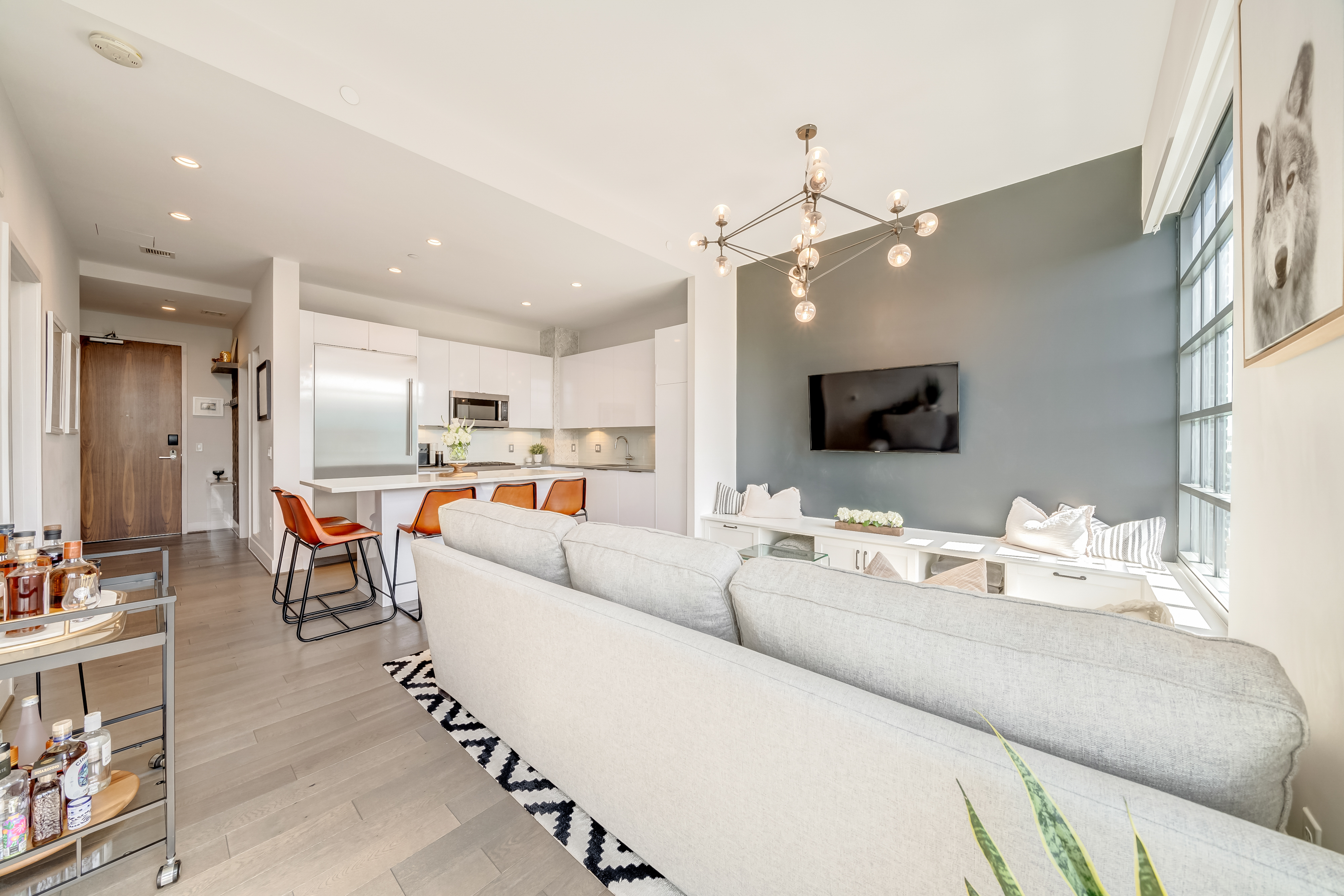 45 Sutton Square Southwest, Unit PH10 Washington, DC 20024 - Photo 6 of 44 a living room with furniture kitchen view and a chandelier