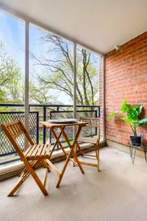a view of a room with wooden floor chair and windows