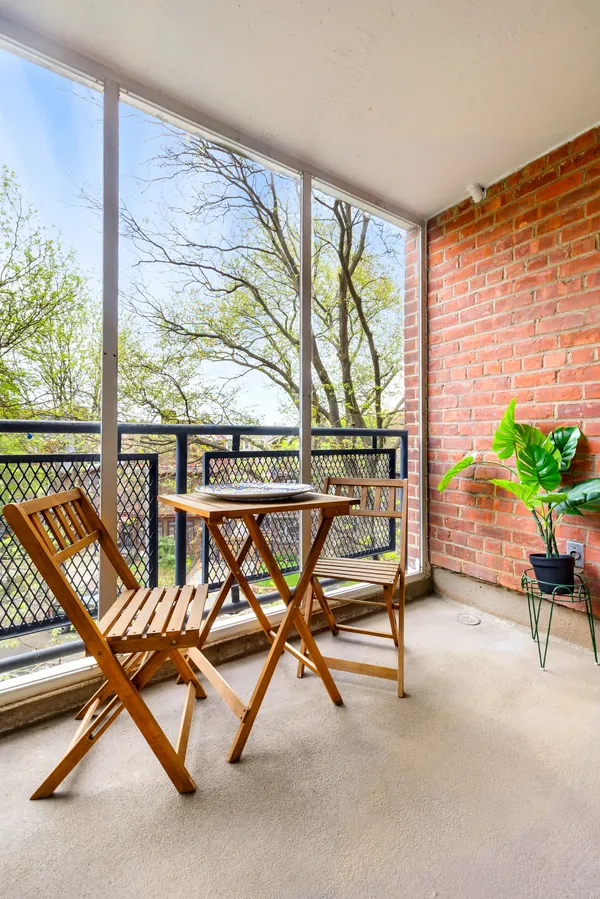 a view of a room with wooden floor chair and windows