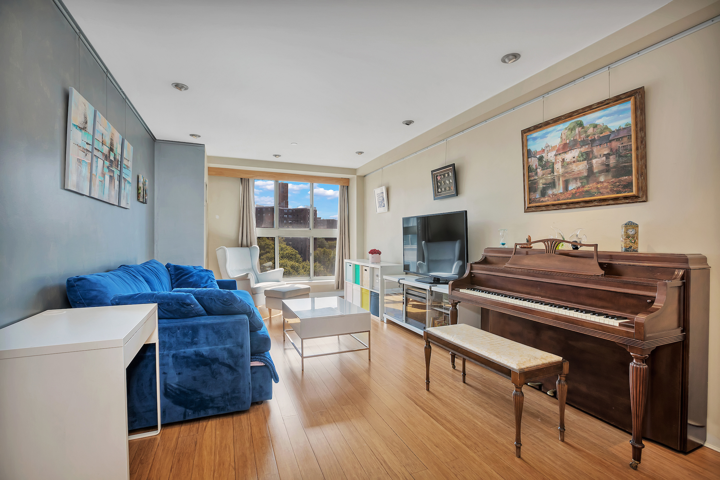 1400 5th Avenue, Unit 8J Manhattan, NY 10026 - Photo 3 of 10 a living room with furniture and a flat screen tv