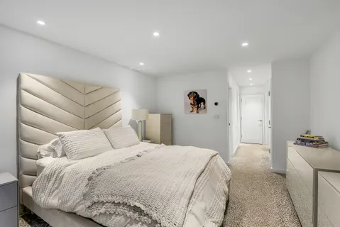 a bedroom with a bed and a large mirror