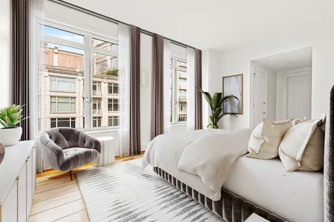 a bedroom with a bed and glass window