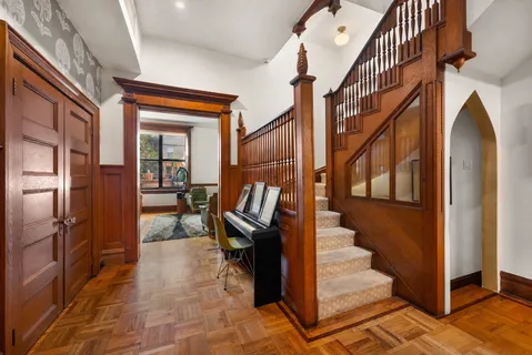 a view of staircase with lots of frames on wall and stairs