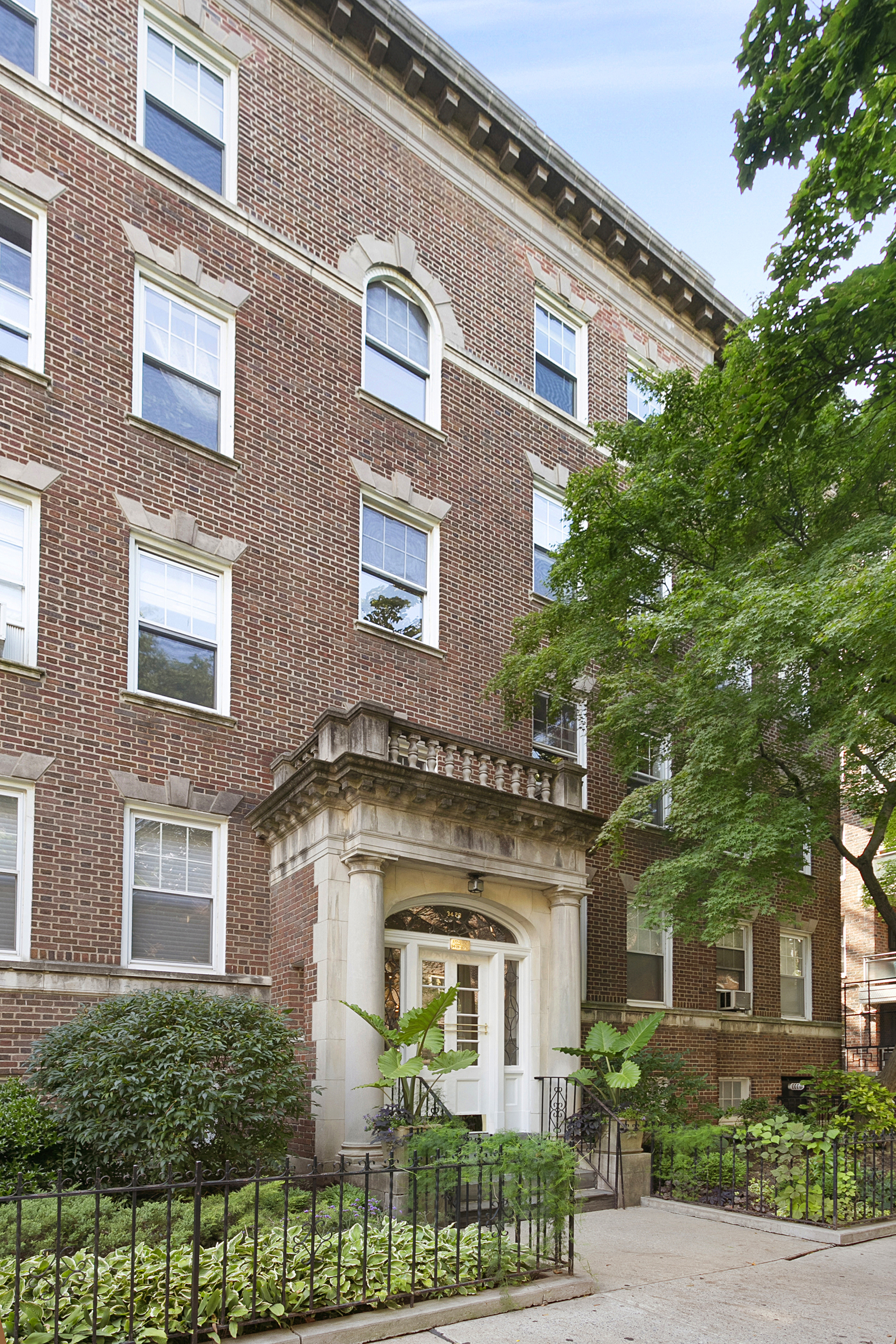 34-28 80th Street, Unit 2 Queens, NY 11372 - Photo 11 of 12 a front view of a house with a garden