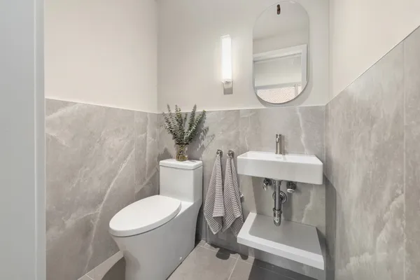 a white toilet sitting next to a bathroom sink