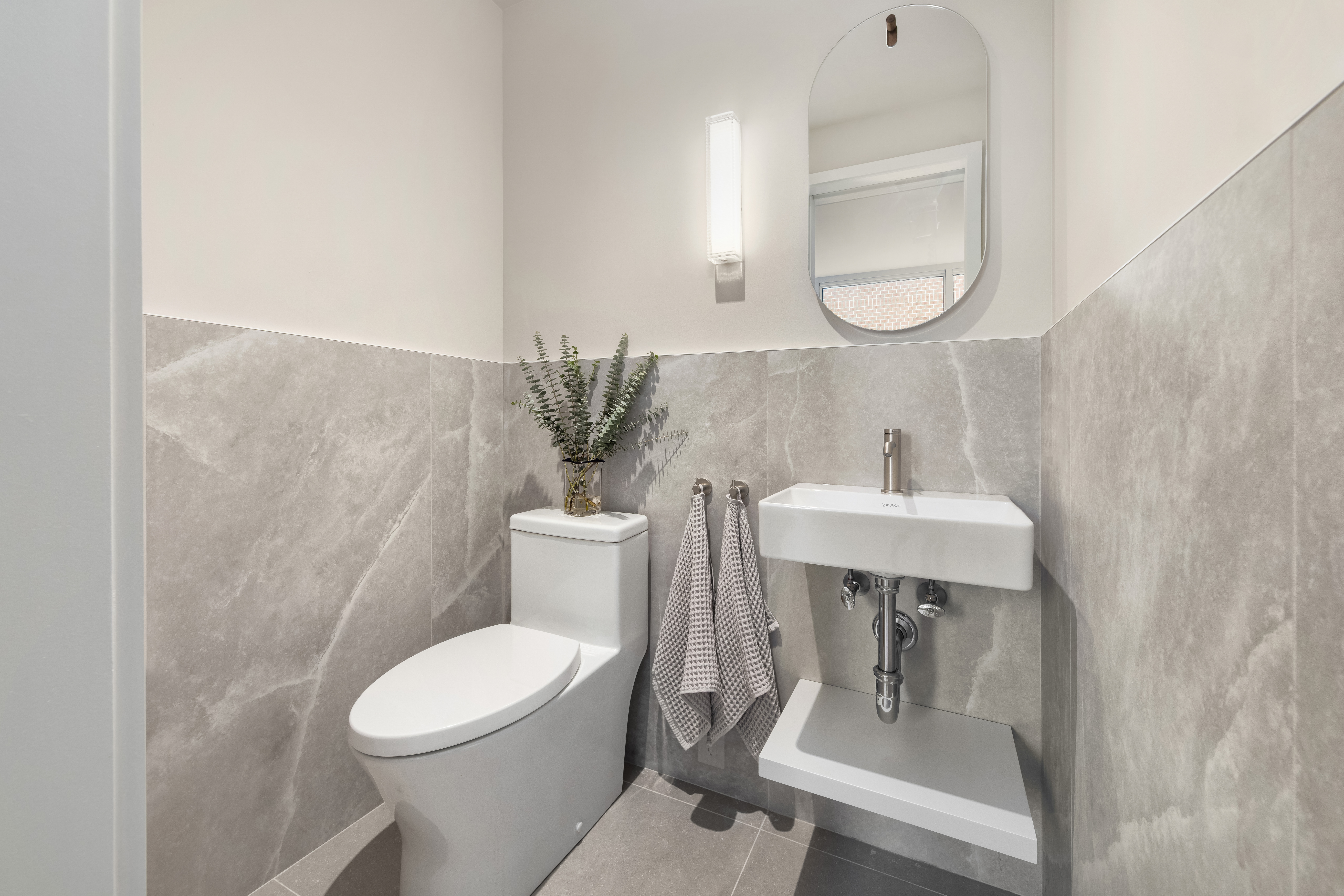 404 East 76th Street, Unit 2B Manhattan, NY 10021 - Photo 19 of 24 a white toilet sitting next to a bathroom sink