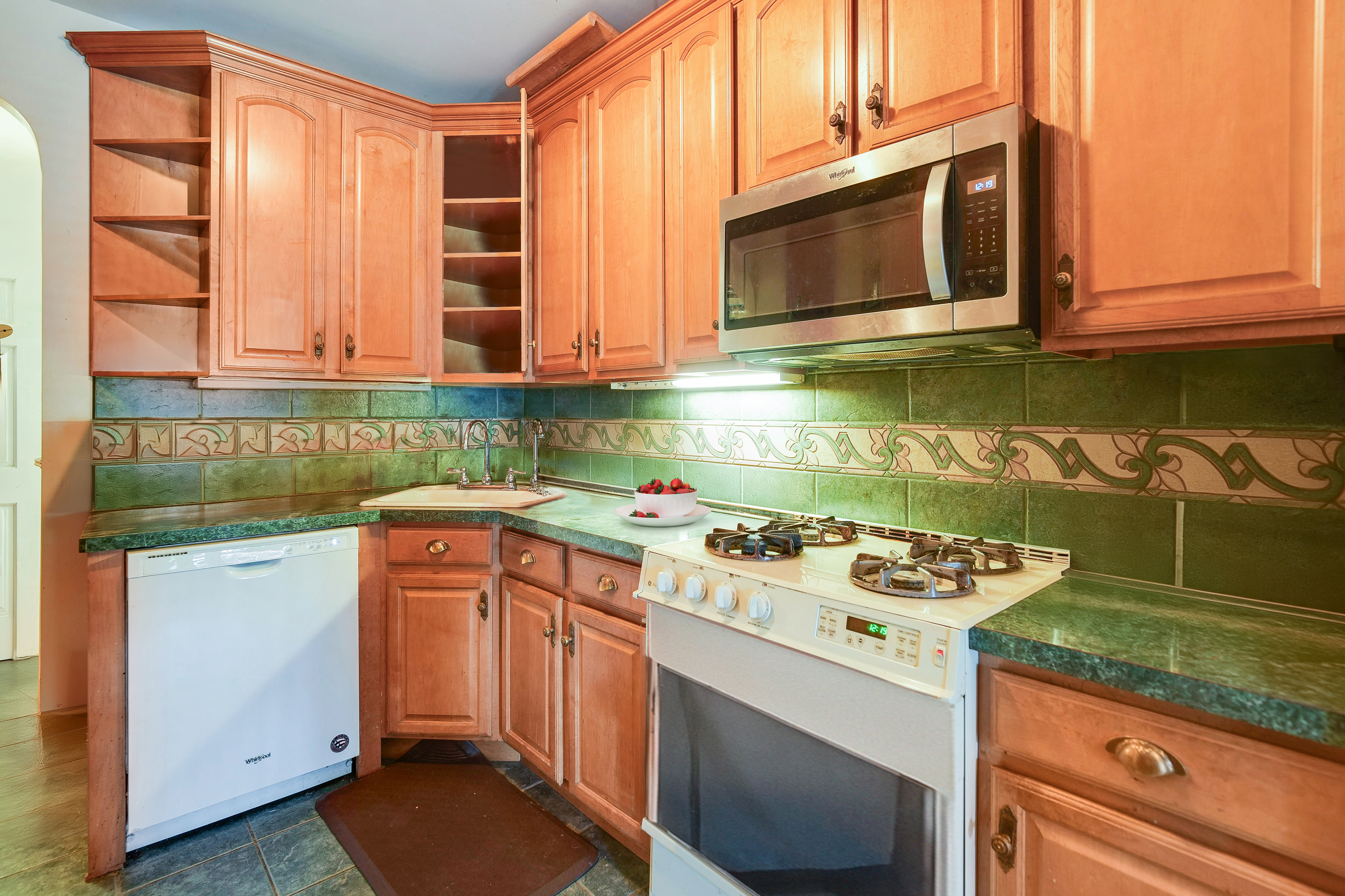 233 Battery Avenue Brooklyn, NY 11209 - Photo 5 of 26 a kitchen with a stove and a microwave