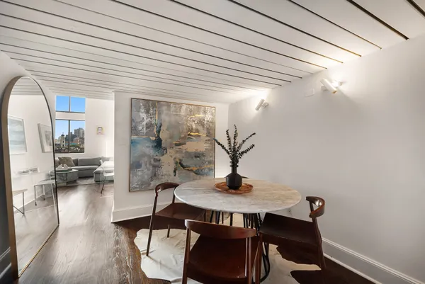a dining room with furniture and wooden floor