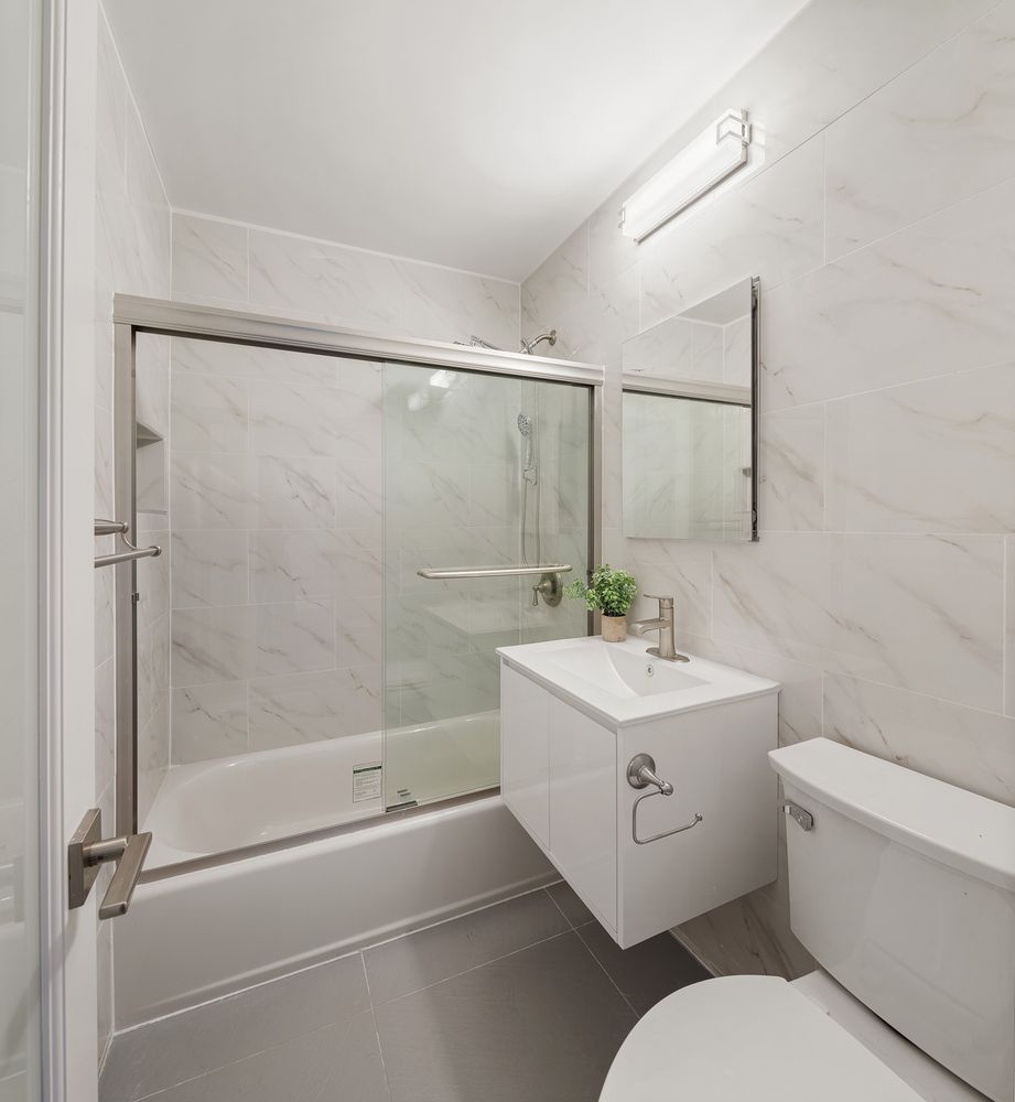 a bathroom with a sink toilet and shower