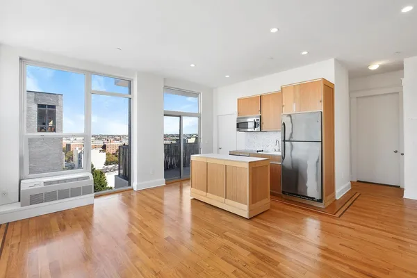 a kitchen with stainless steel appliances granite countertop a refrigerator and a stove top oven