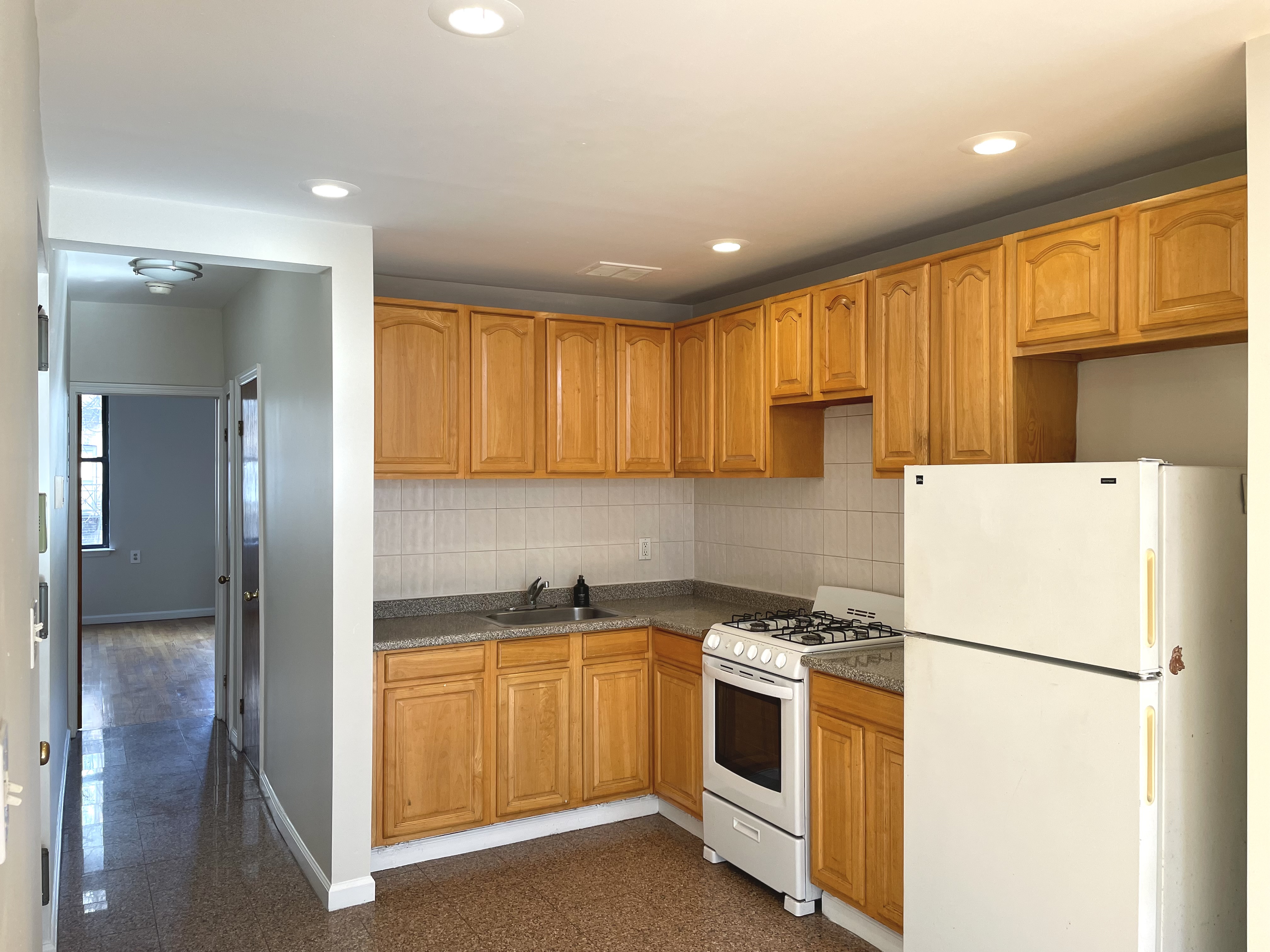 95 St Marks Place, Unit 6 Manhattan, NY 10009 - Photo 4 of 14 a kitchen with a refrigerator and a sink