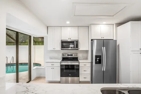 a kitchen with a refrigerator a stove and a sink
