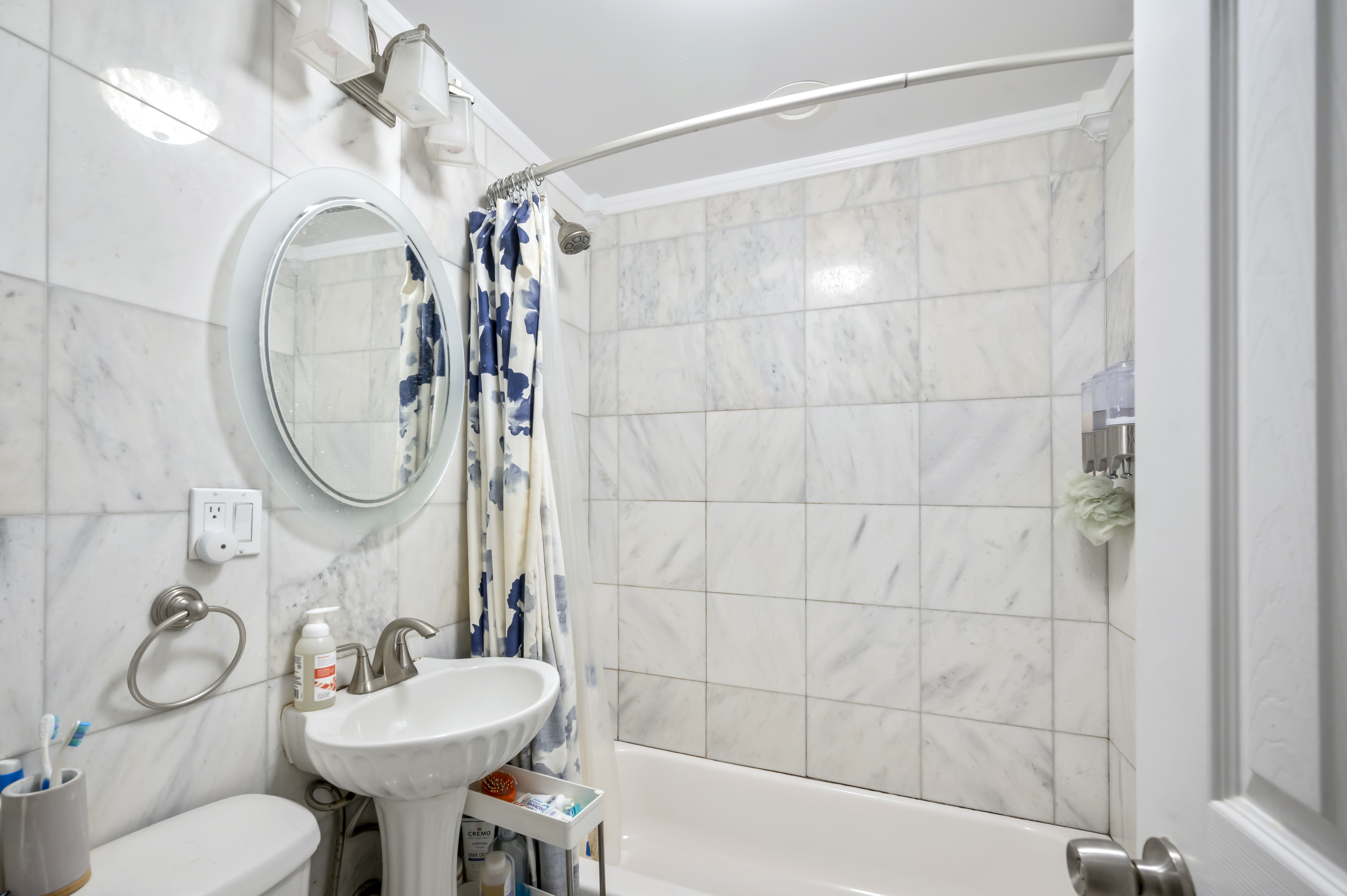 53 West 94th Street Manhattan, NY 10025 - Photo 7 of 12 a bathroom with a toilet a sink and mirror