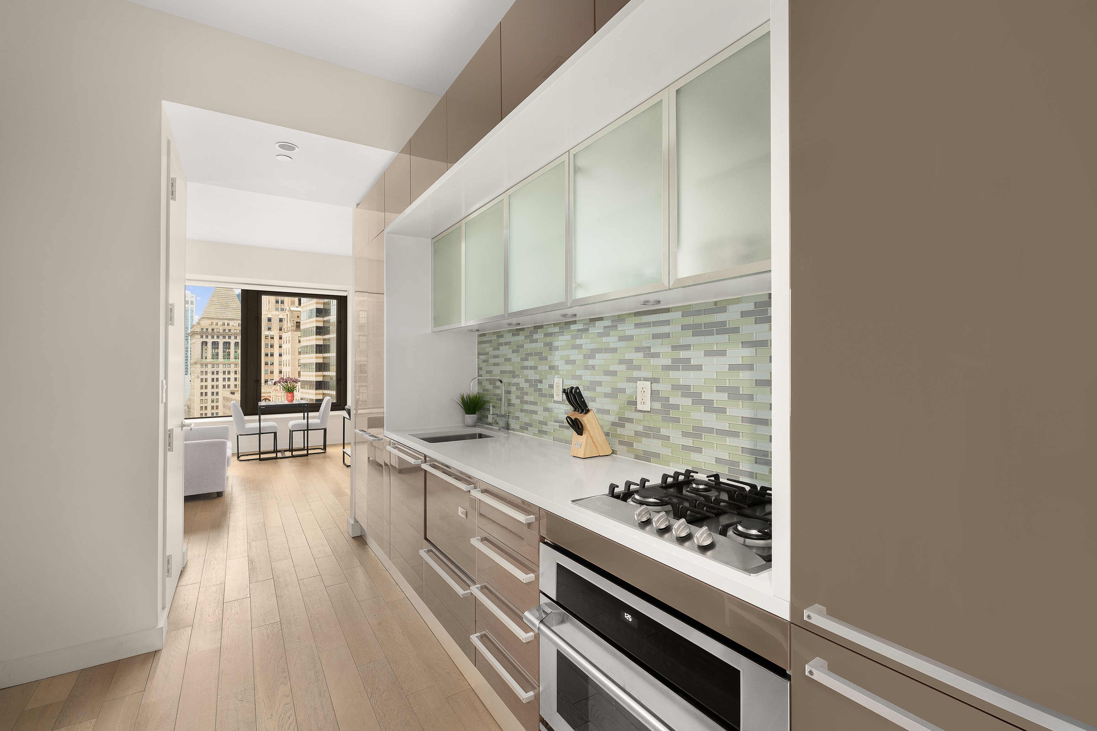 75 Wall Street, Unit 33L Manhattan, NY 10005 - Photo 4 of 5 a kitchen with a sink and a stove top oven