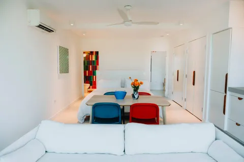 a bedroom with a bed and large window