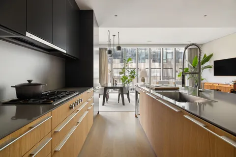 a kitchen with stainless steel appliances granite countertop a sink a stove and a refrigerator