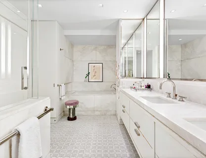 a bathroom with a tub sink and mirror