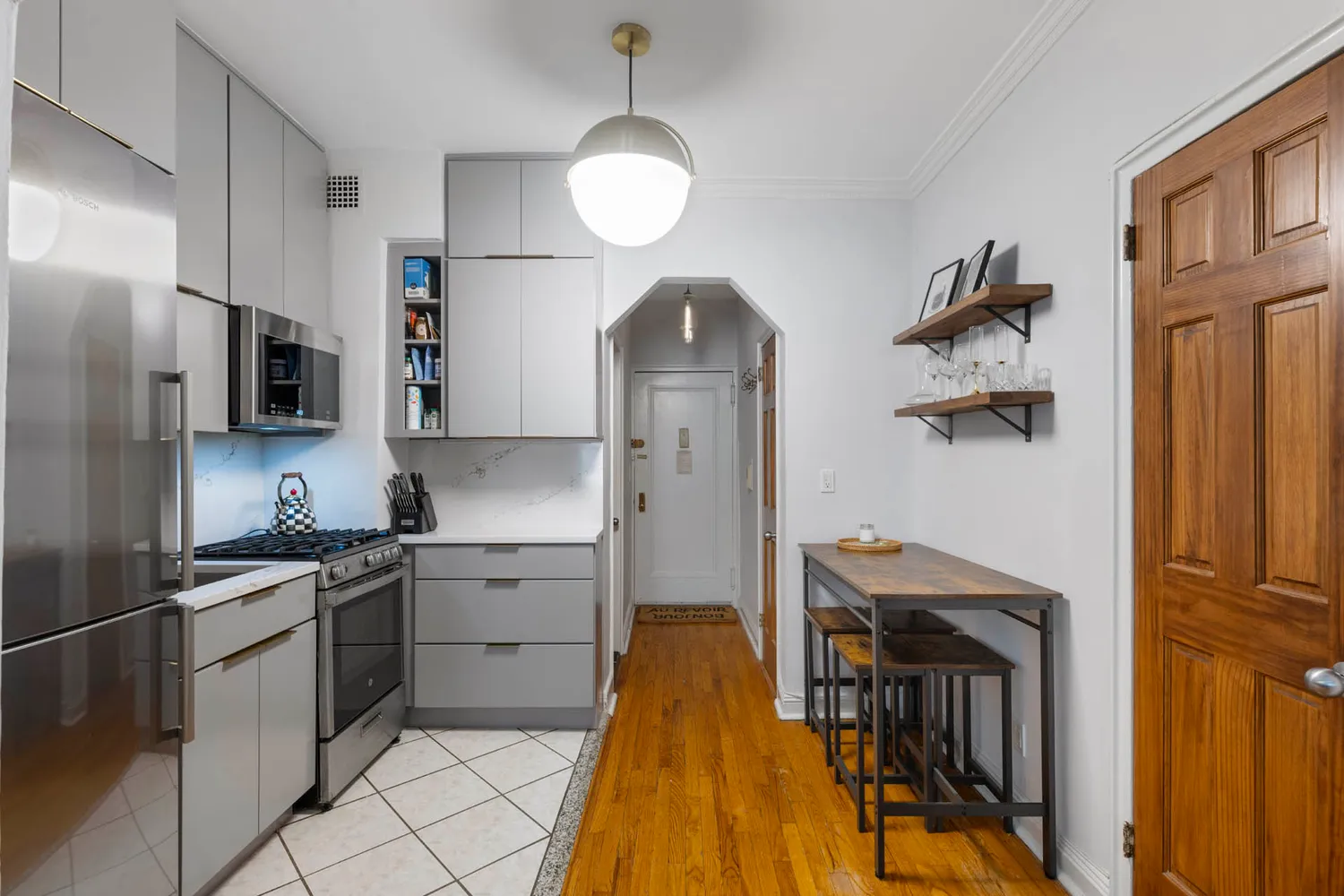 a kitchen with stainless steel appliances granite countertop a refrigerator a stove and a sink