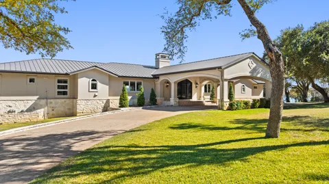 a swimming pool with trees in front of it