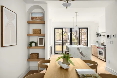 a living room with fireplace furniture and a floor to ceiling window