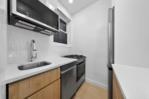 a kitchen with a sink and a stove top oven