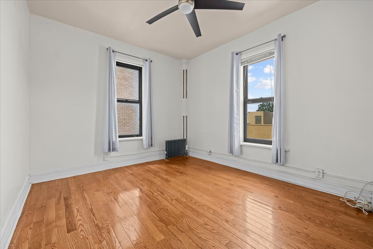 1710 Carroll Street, Unit D4 Brooklyn, NY 11213 - Photo 5 of 16 a view of an empty room with a window and wooden floor