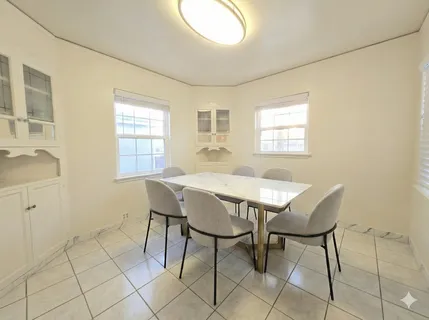 a view of a dining room with furniture and window
