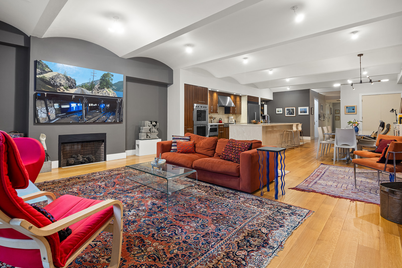 42 Ann Street, Unit 7 Manhattan, NY 10038 - Photo 4 of 16 a living room with furniture a red rug and a fireplace