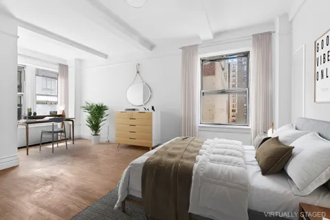 a bedroom with a bed a table and chair