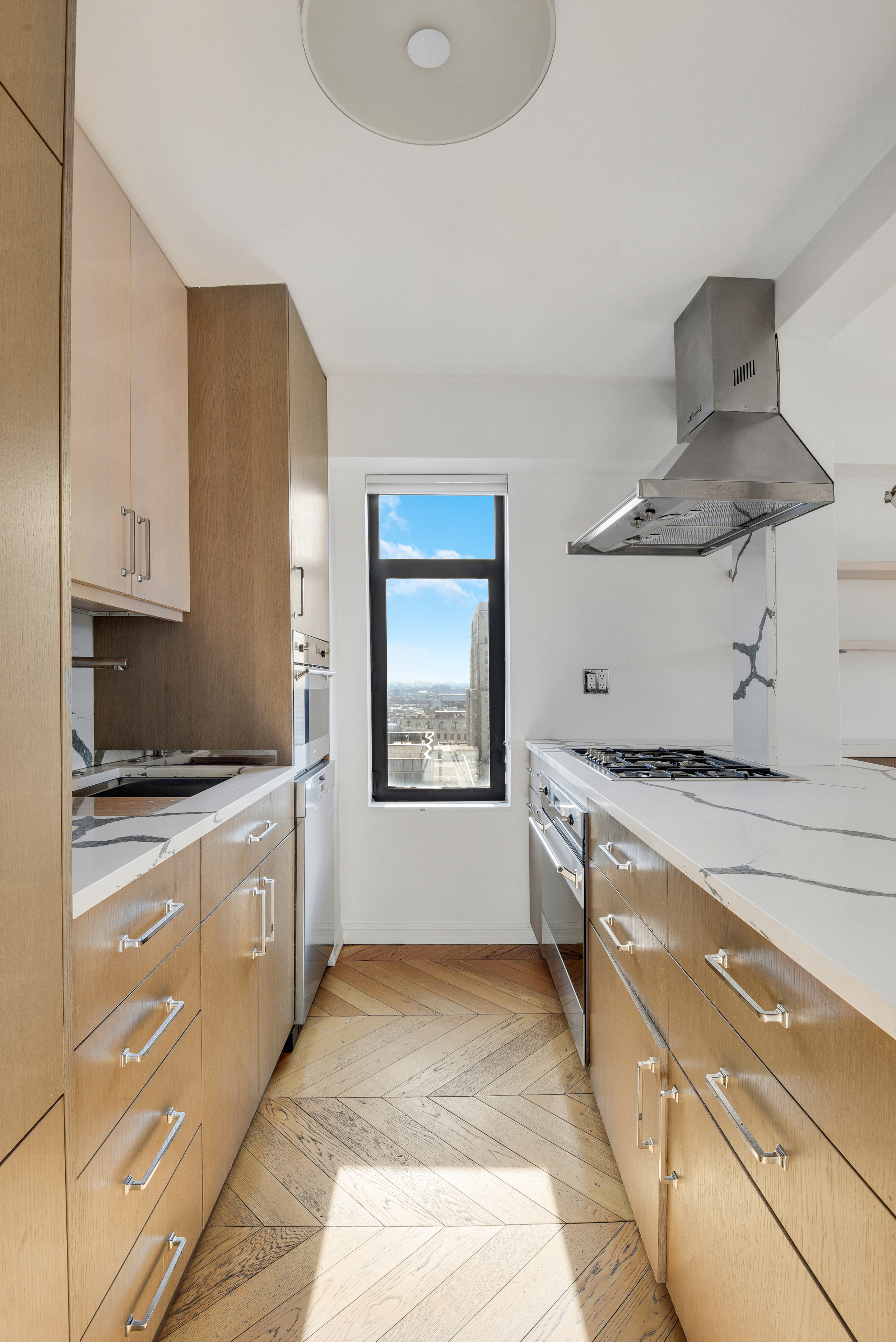 400 East 70th Street, Unit 3005 Manhattan, NY 10021 - Photo 7 of 18 a kitchen with a stove a sink and a refrigerator