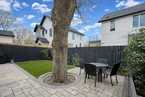 a view of a chairs and table in backyard