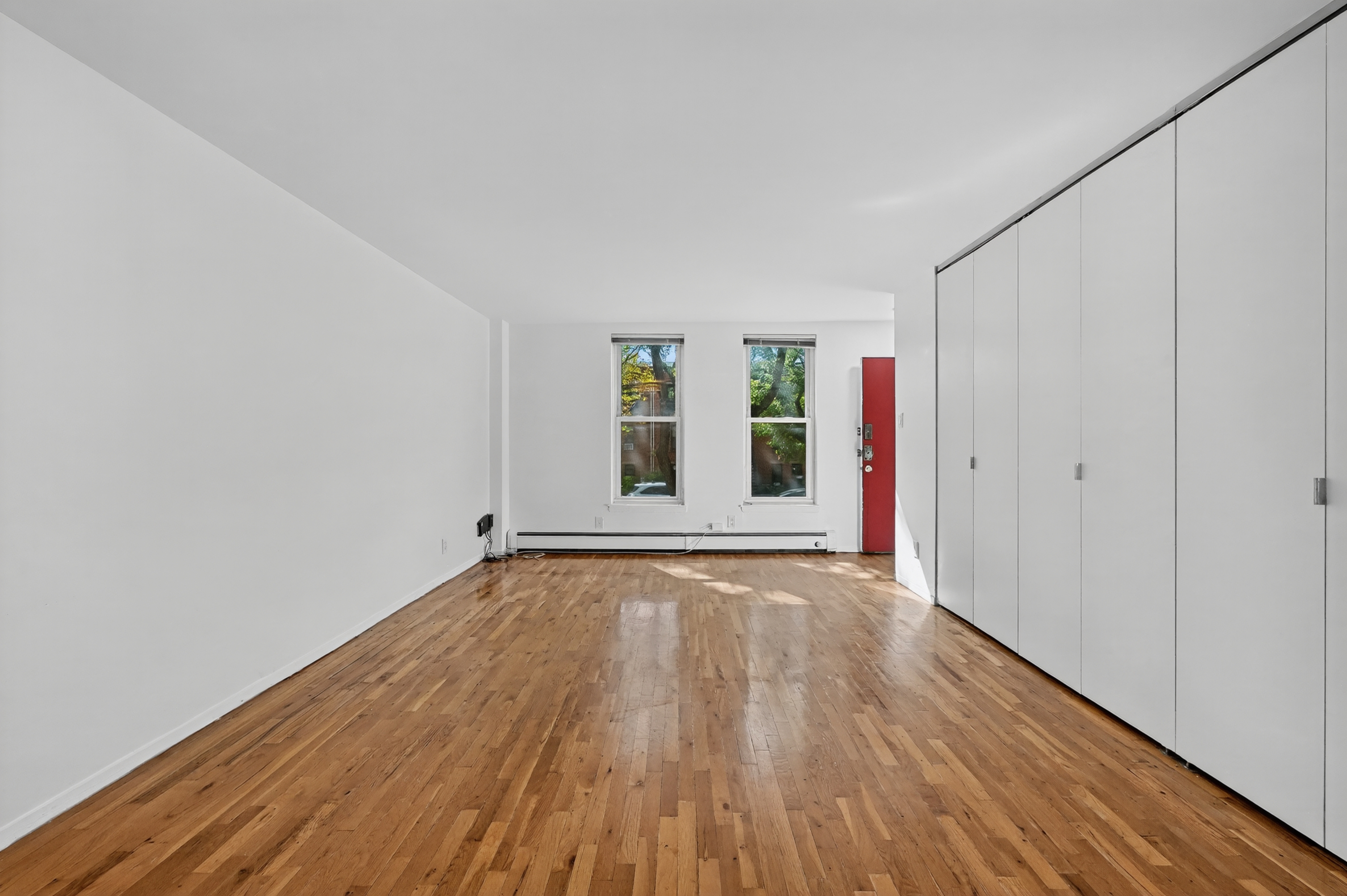 81 President Street, Unit 51-A Brooklyn, NY 11231 - Photo 8 of 27 a view of an empty room with wooden floor and window