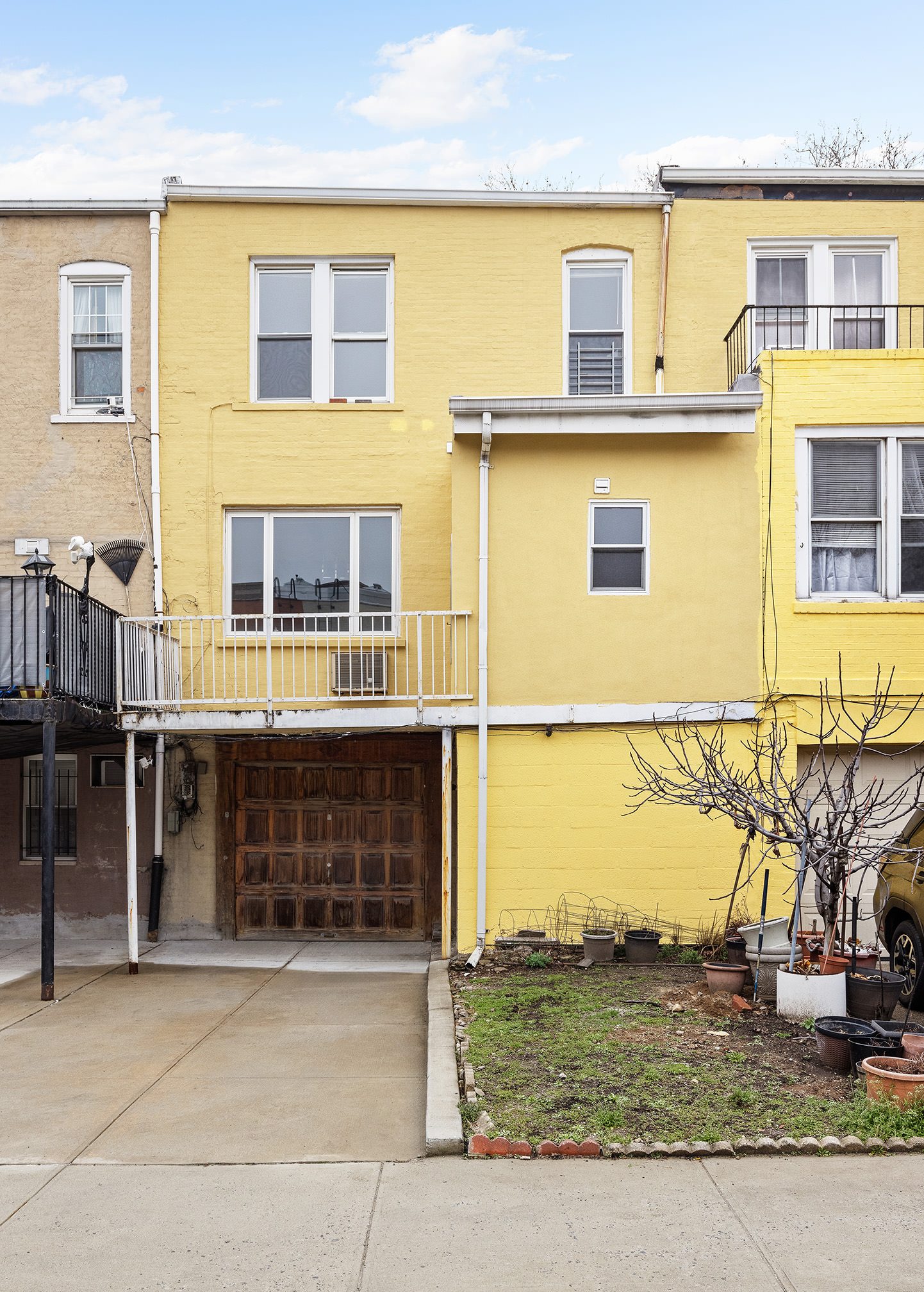 31-22 36th Street Queens, NY 11106 - Photo 9 of 10 a front view of a residential apartment building with a yard