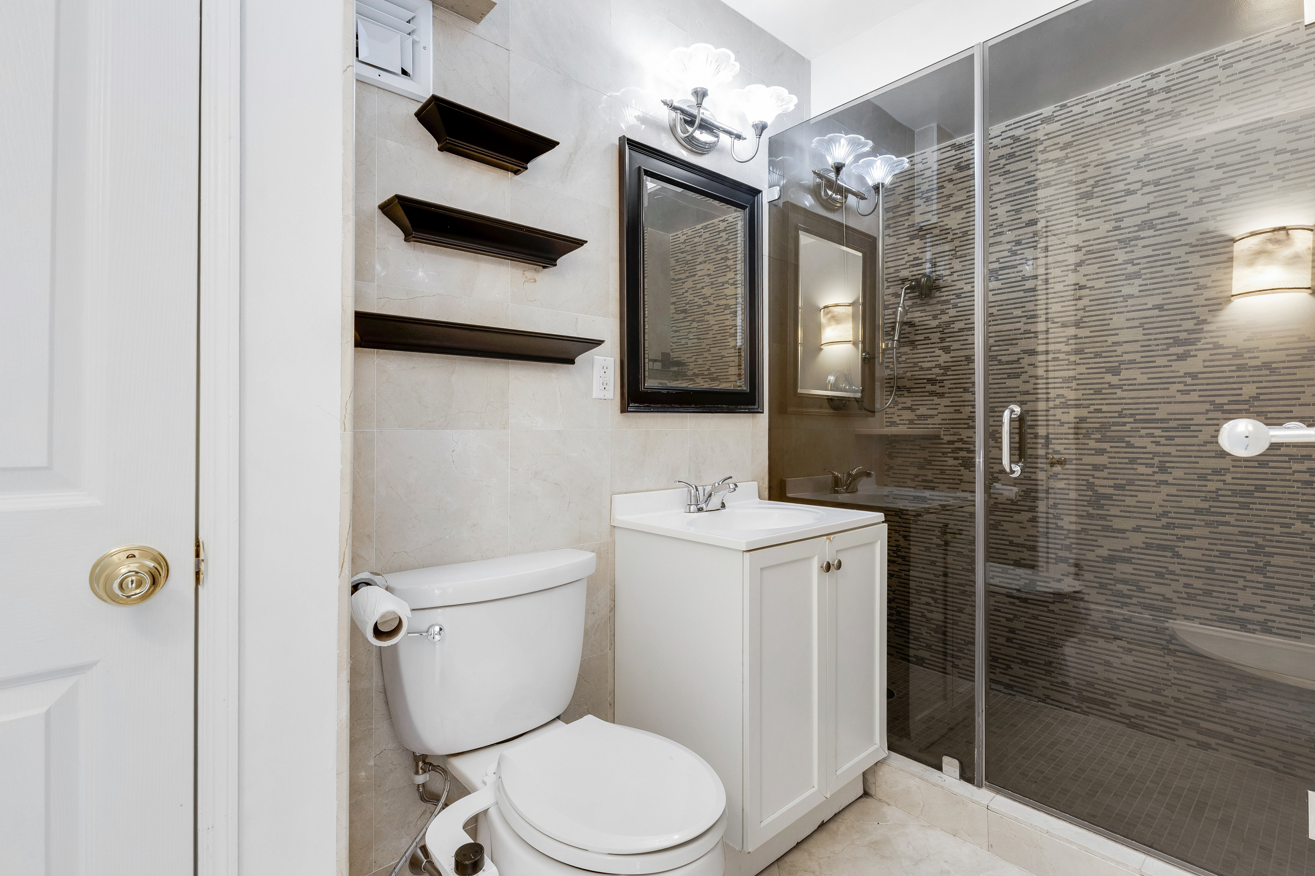 200 Central Park South, Unit 19K Manhattan, NY 10019 - Photo 7 of 14 a bathroom with a toilet a sink and mirror