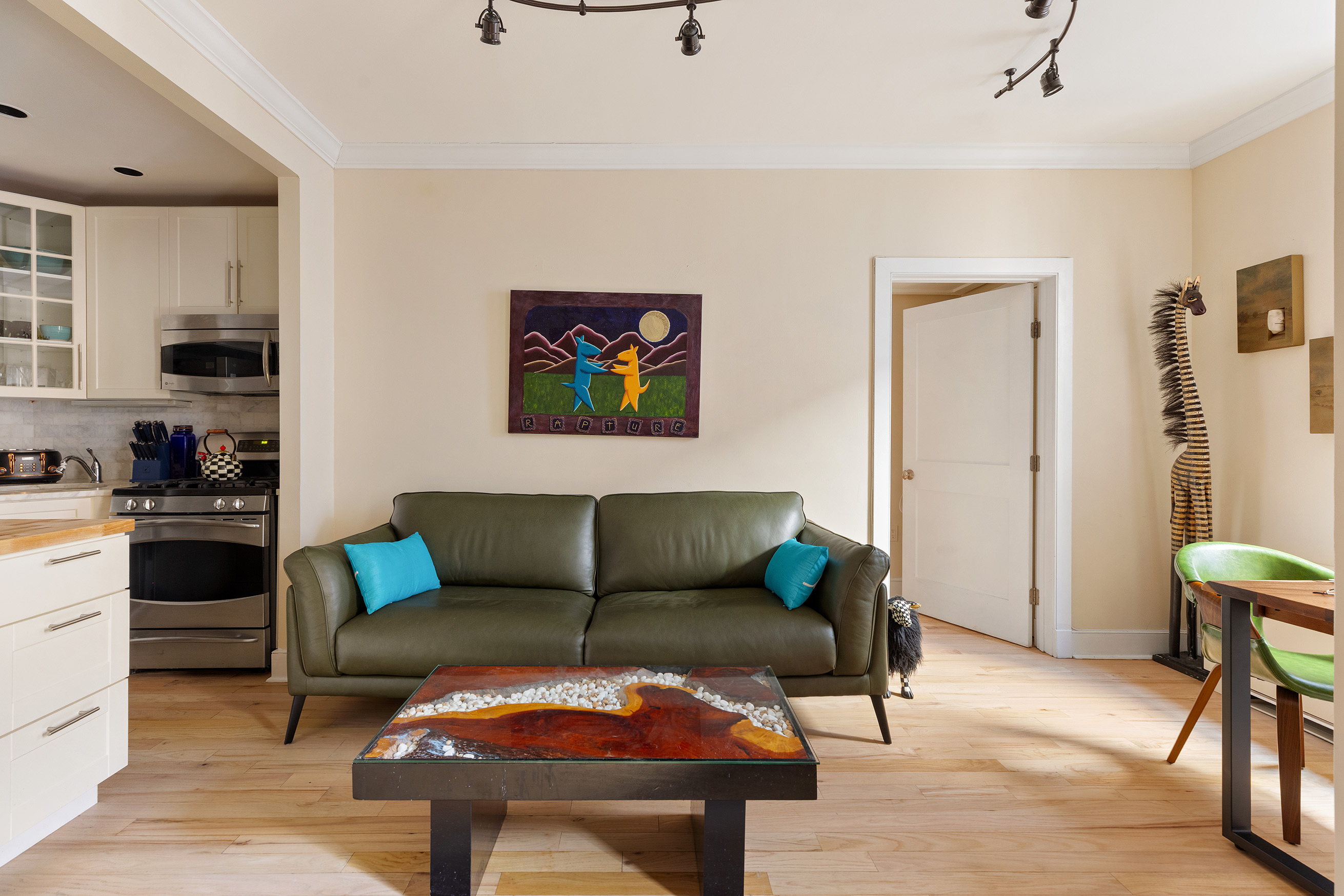 555 Lenox Avenue, Unit 3C Manhattan, NY 10030 - Photo 2 of 7 a living room with furniture wall paintings and a window