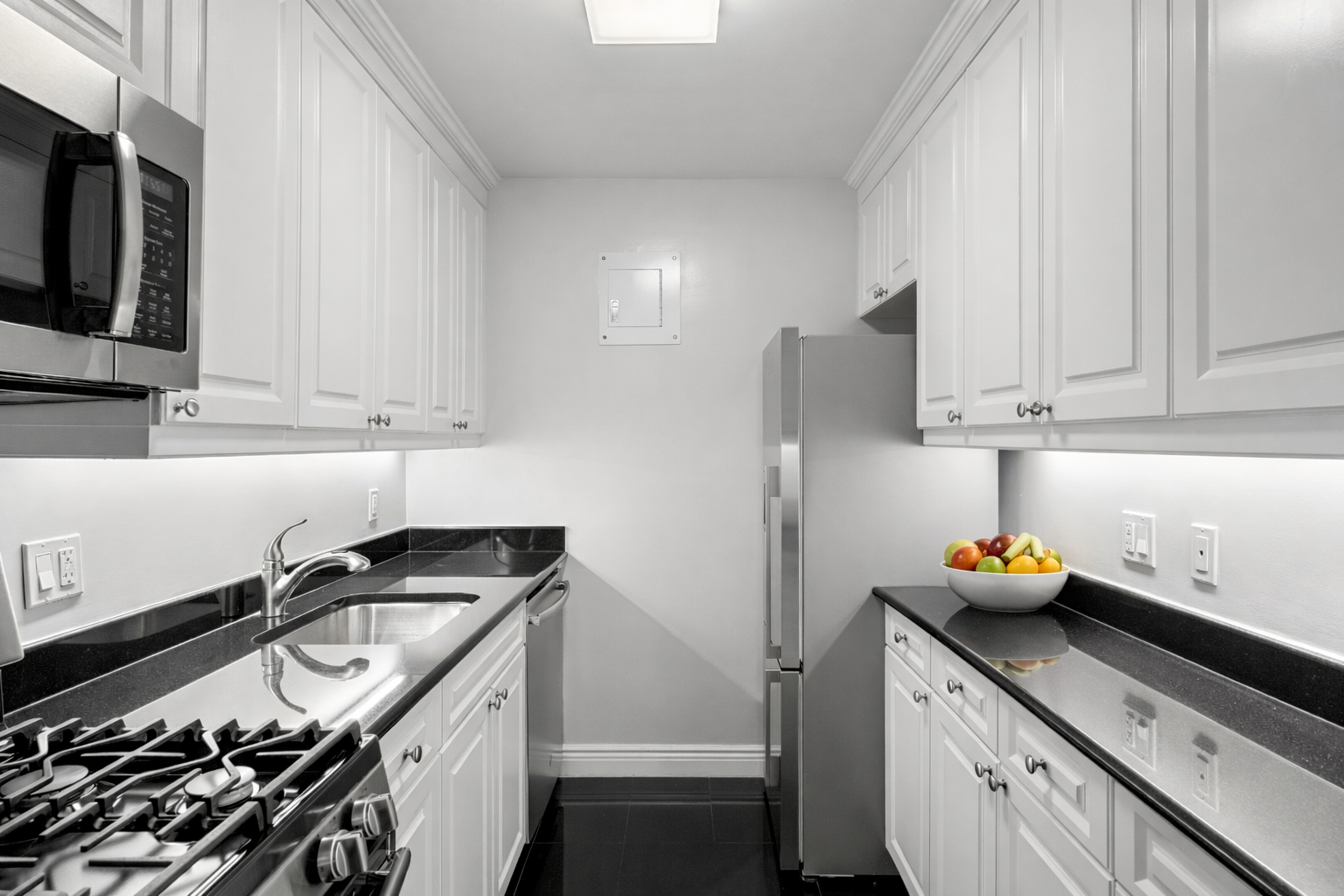155 West 68th Street, Unit 815 Manhattan, NY 10023 - Photo 7 of 14 a kitchen with stainless steel appliances granite countertop a sink stove and refrigerator