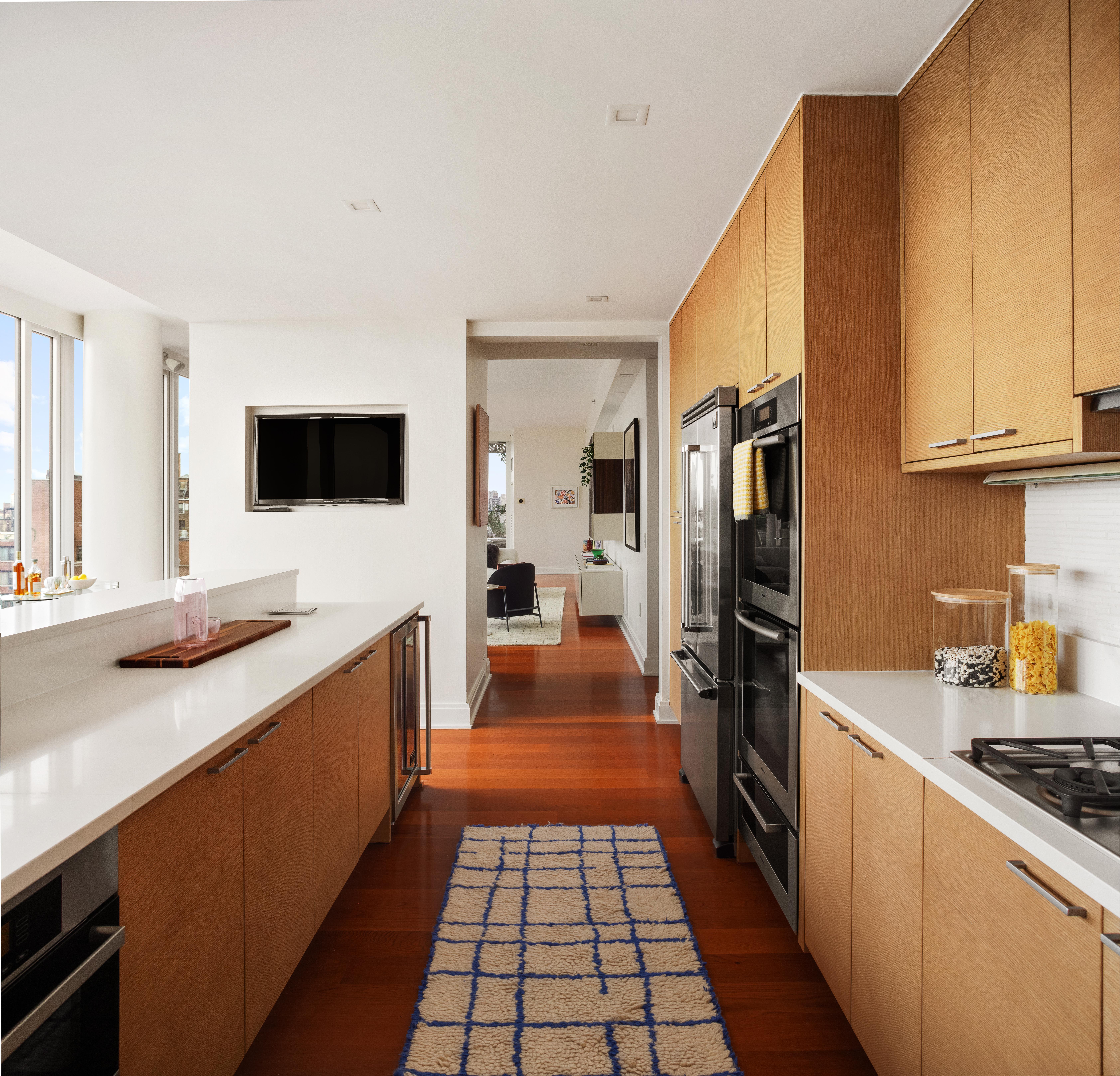 230 West 78th Street, Unit PH19 Manhattan, NY 10024 - Photo 5 of 17 a kitchen with stainless steel appliances a stove a sink and a refrigerator