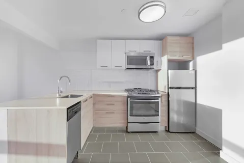 a kitchen with a stove sink and a refrigerator