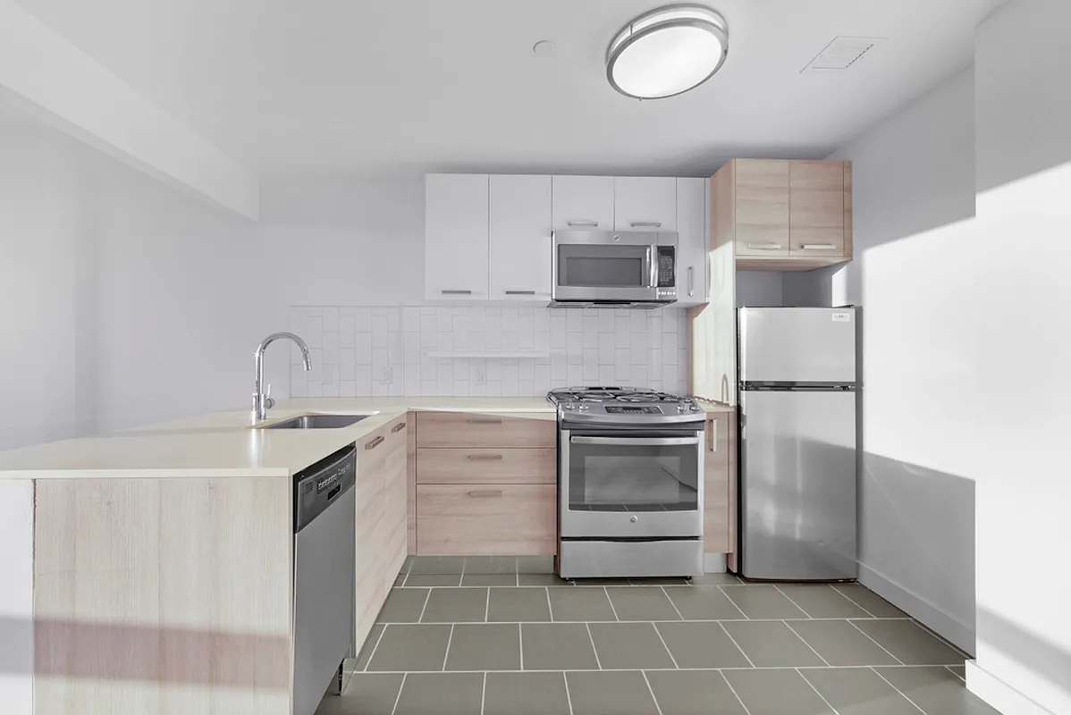 a kitchen with a stove sink and a refrigerator